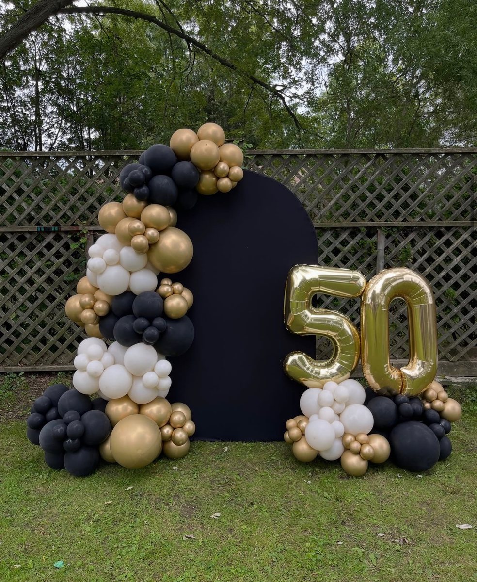 The finished 50th anniversary garland on a black arch