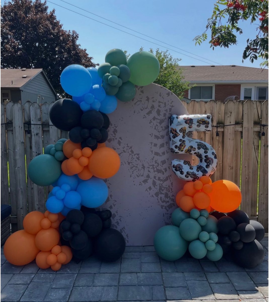 The finished monster truck birthday garland in a backyard